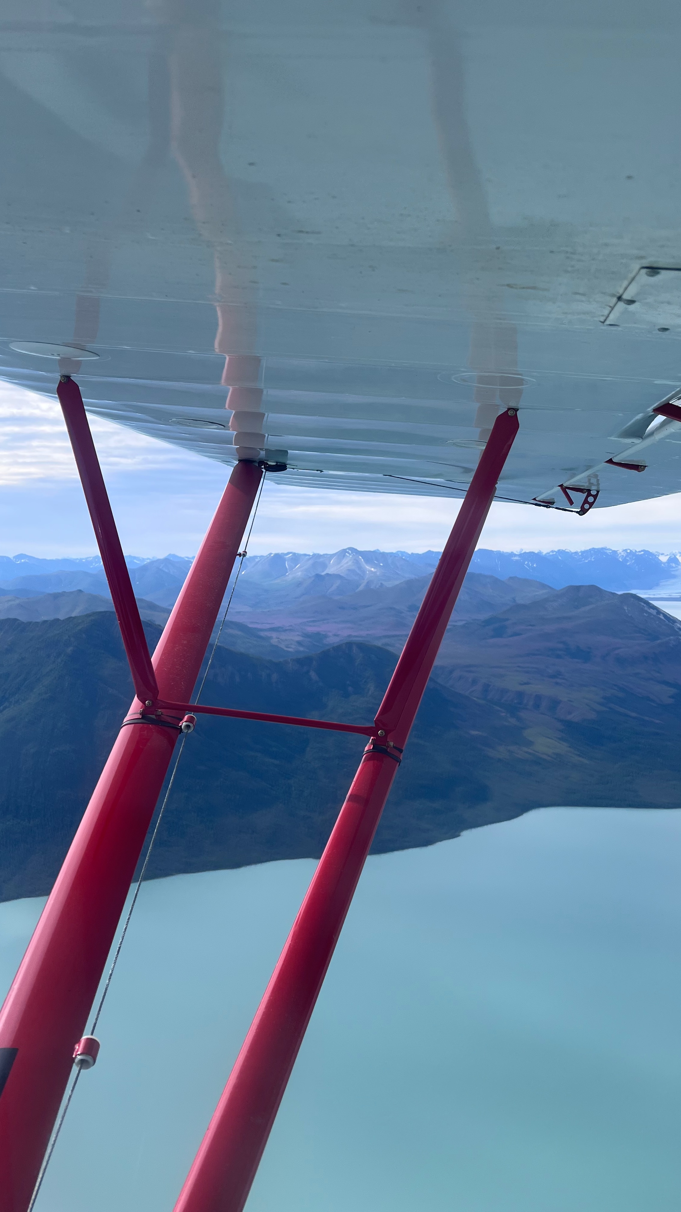Turquoise lake and the Wrangells under the wing